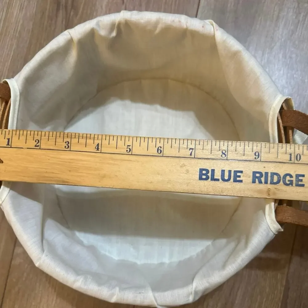 Longaberger Round Basket 10”with leather handles lace trim liner 1990 signed.